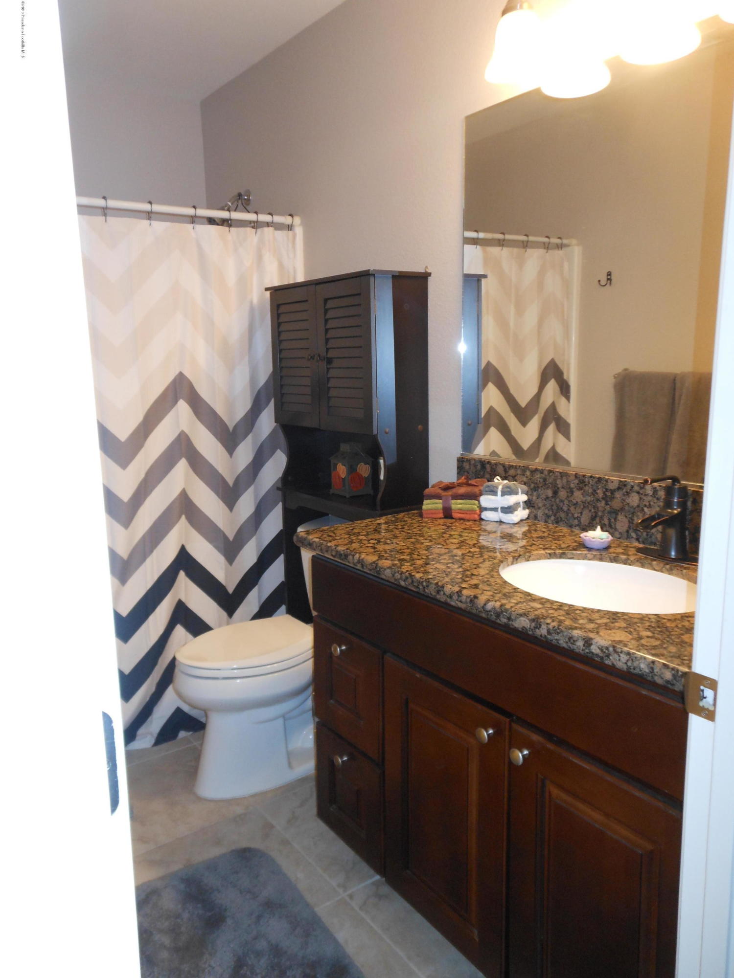 14806 Cheyenne Road Apple Valley, CA 92307 - Photo 9 of 15 a bathroom with a granite countertop sink toilet and shower