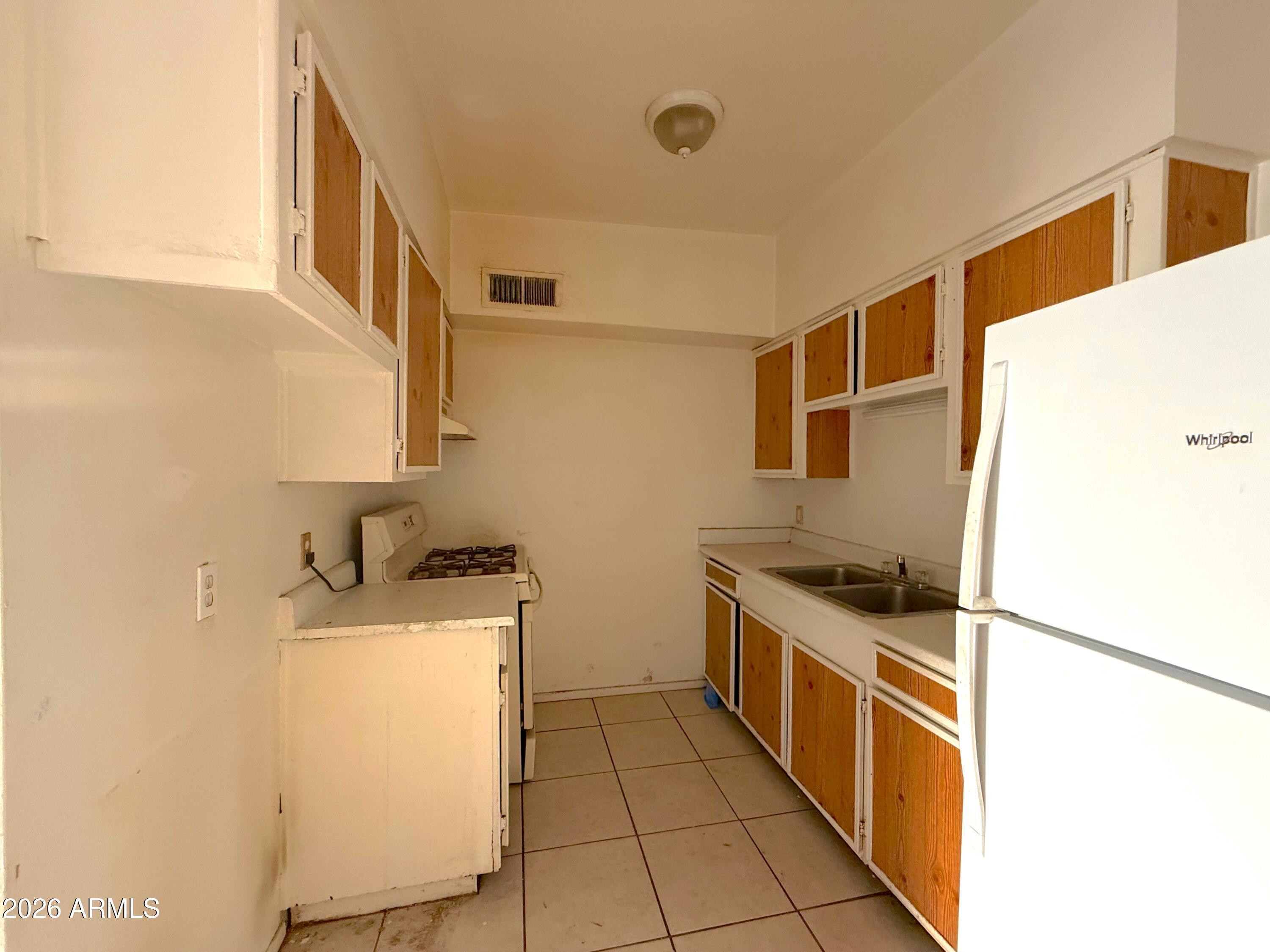 433 West Ray Road, Unit C Chandler, AZ 85225 - Photo 4 of 7 a kitchen with a stove top oven and cabinets