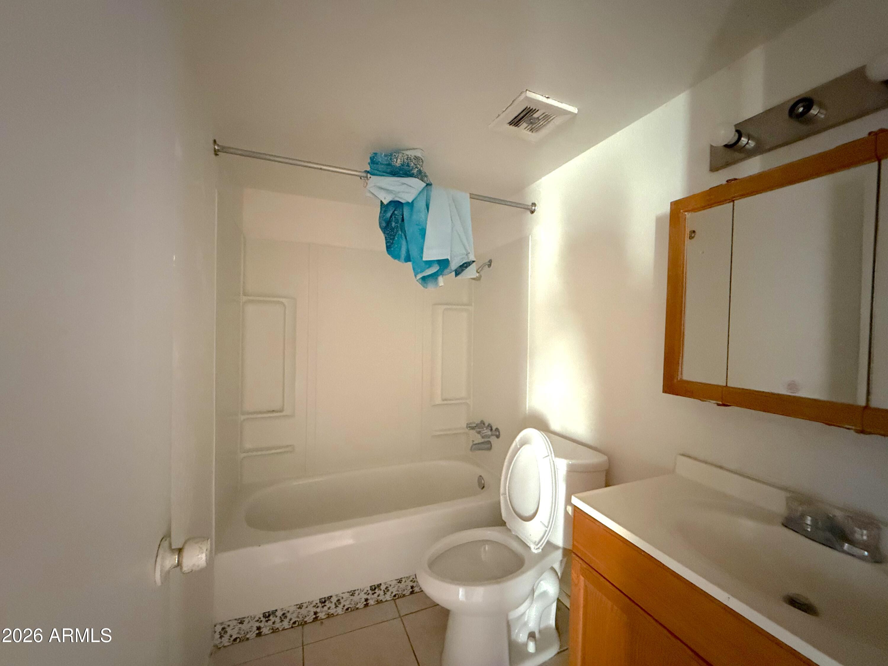 433 West Ray Road, Unit C Chandler, AZ 85225 - Photo 7 of 7 a bathroom with a sink mirror vanity and toilet