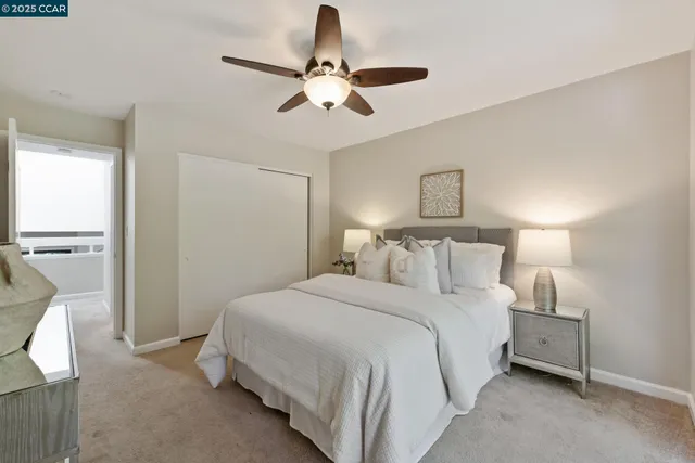 a bedroom with a large bed and a large window