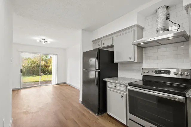 a kitchen with a stove and a refrigerator