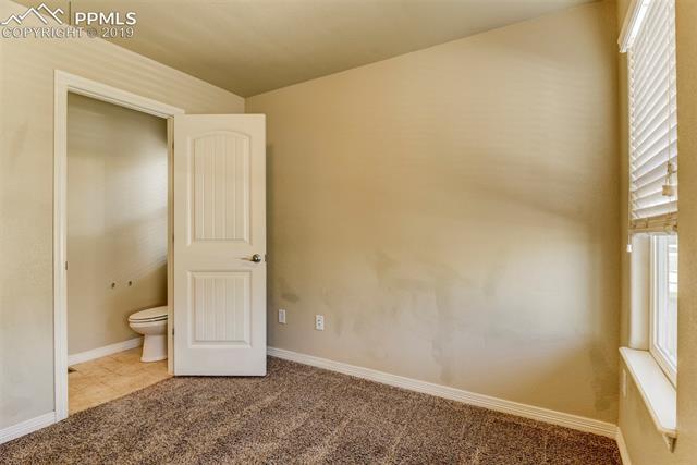 6242 Pilgrimage Road Colorado Springs, CO 80925 - Photo 4 of 7 The formal Living room adjoins to a 1/2 bath with pedestal sink.