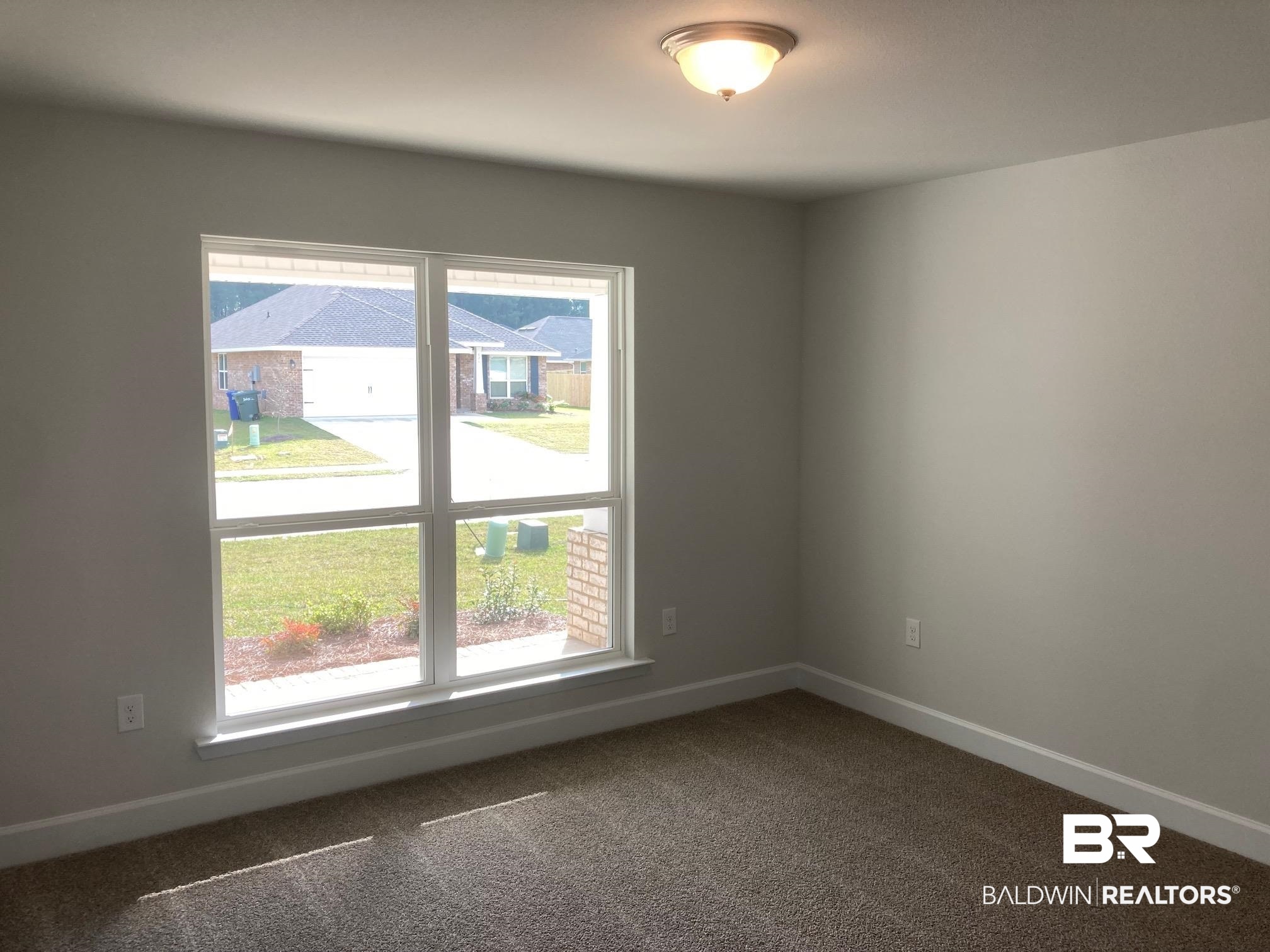629 Revere Street Foley, AL 36535 - Photo 30 of 30 Carpeted empty room with plenty of natural light