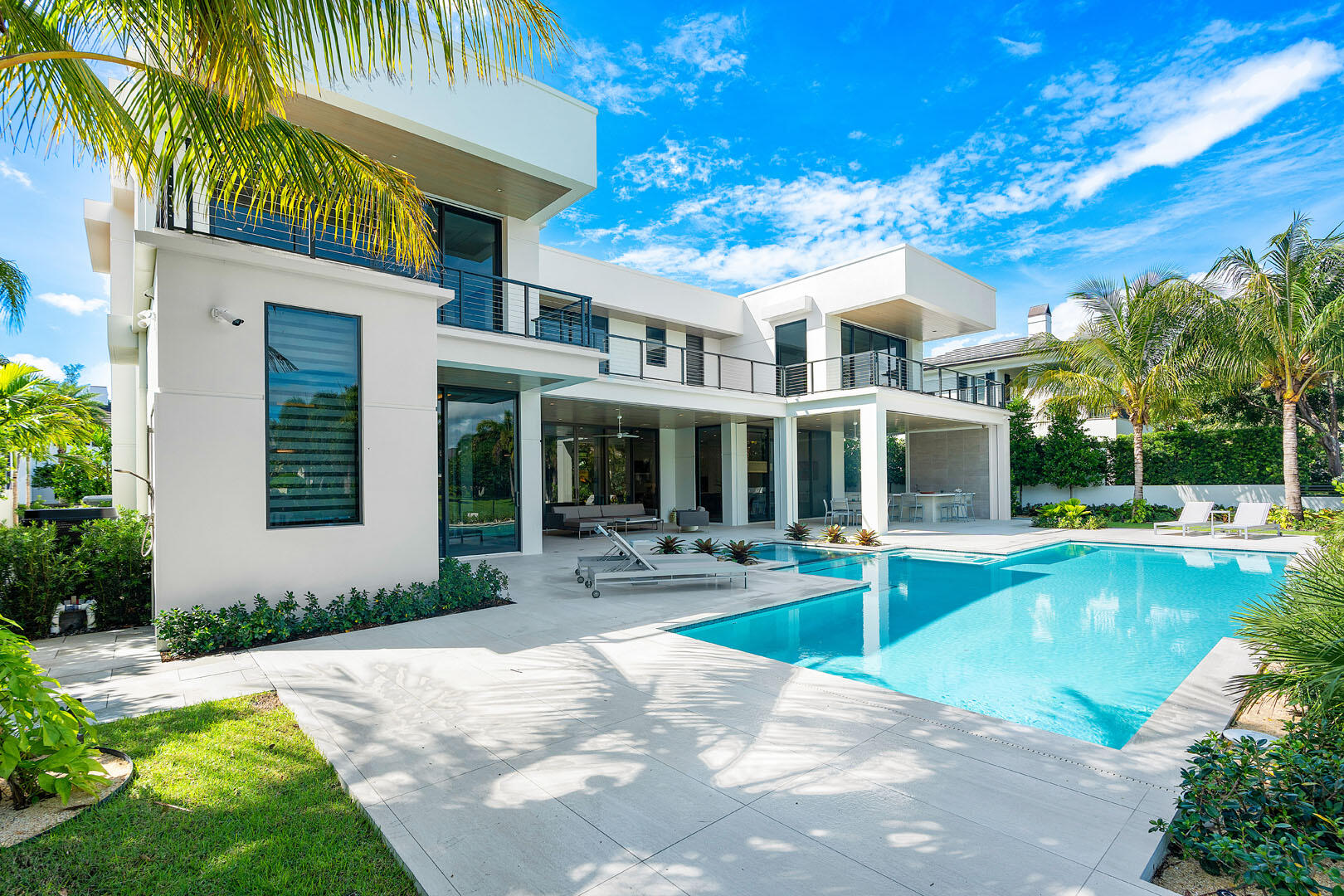 175 Alexander Palm Road Boca Raton, FL 33432 - Photo 22 of 71 a front view of a house with swimming pool having outdoor seating