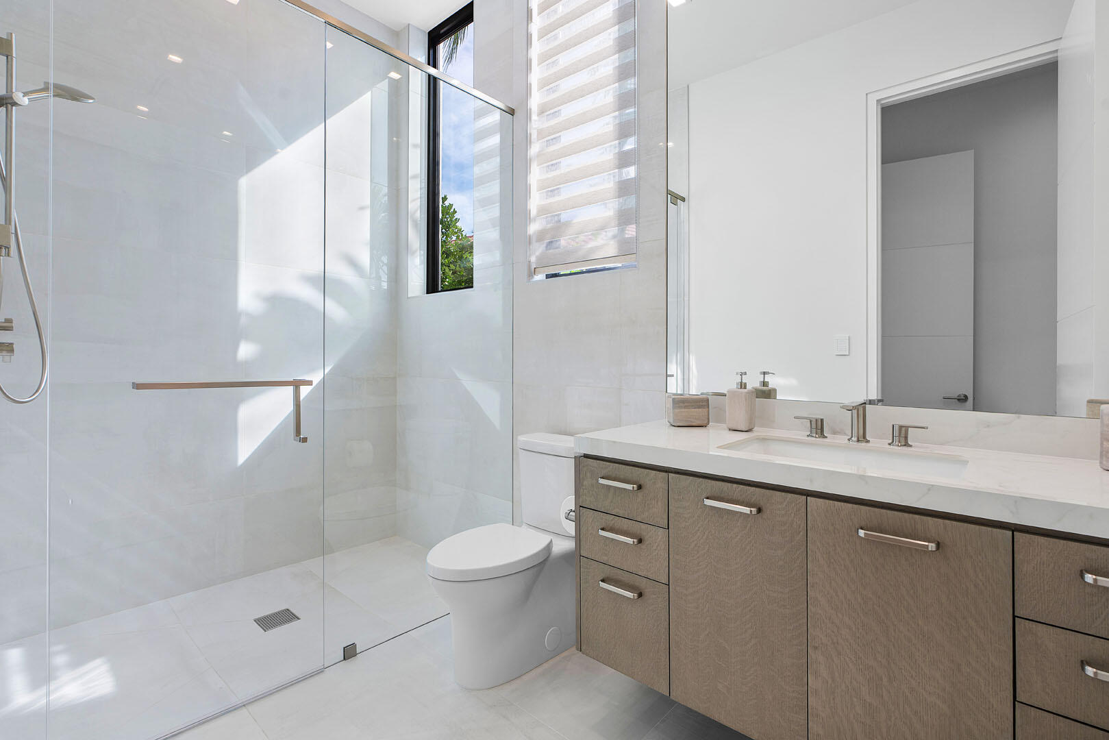 175 Alexander Palm Road Boca Raton, FL 33432 - Photo 31 of 71 a bathroom with a double vanity sink toilet and shower