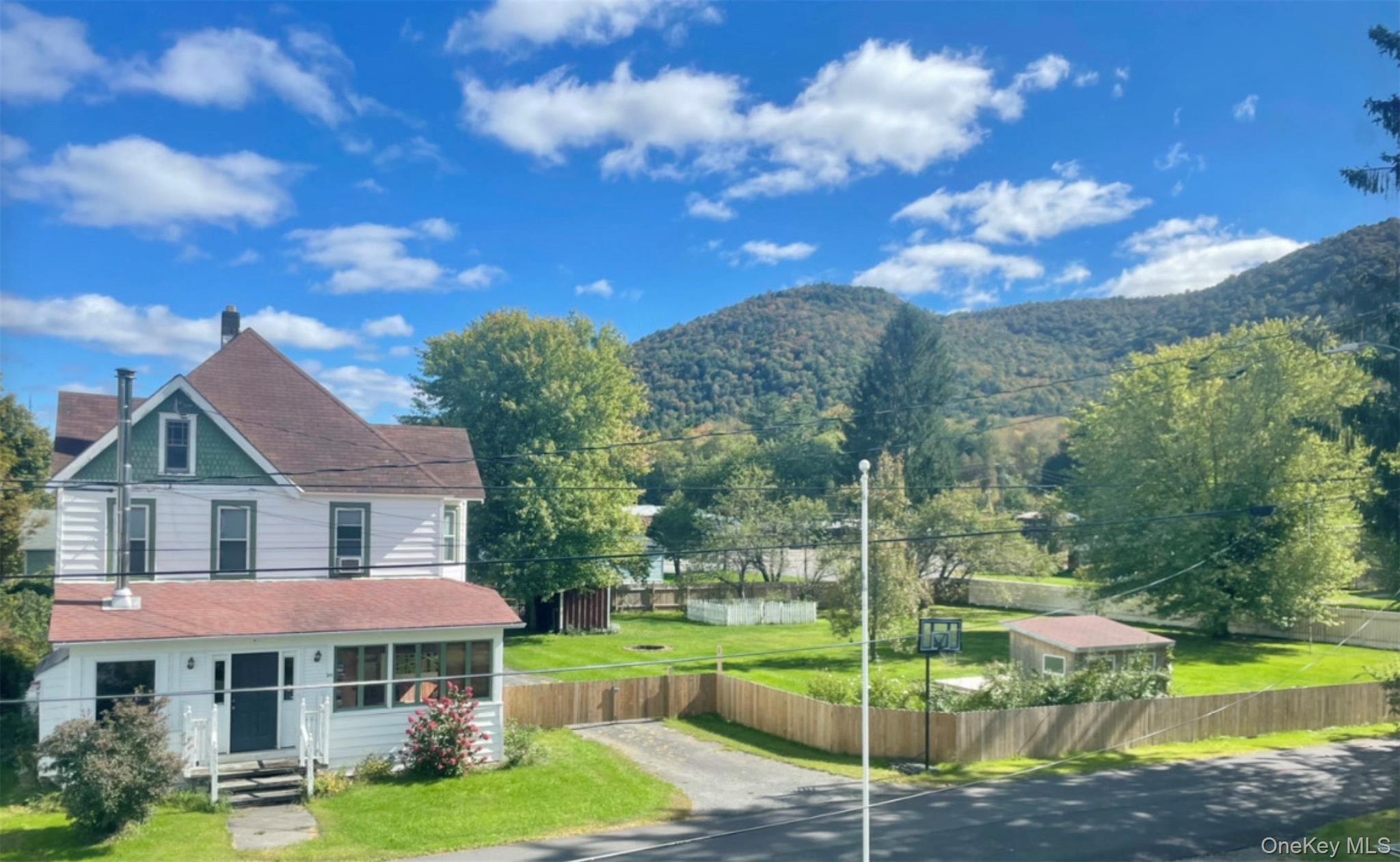 a view of a house with garden and a yard