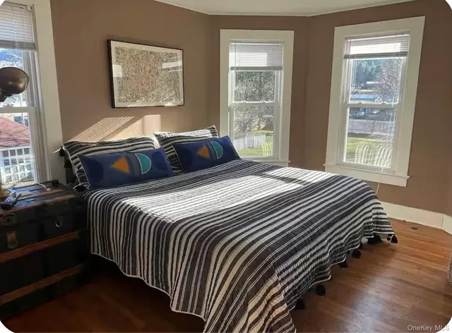 a bedroom with double bed and a window