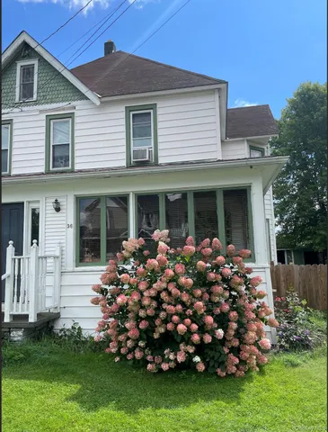 a front view of a house with a garden