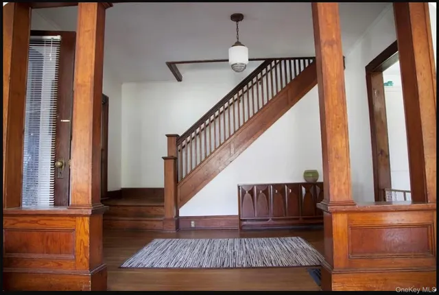 a view of entryway and hall with wooden floor