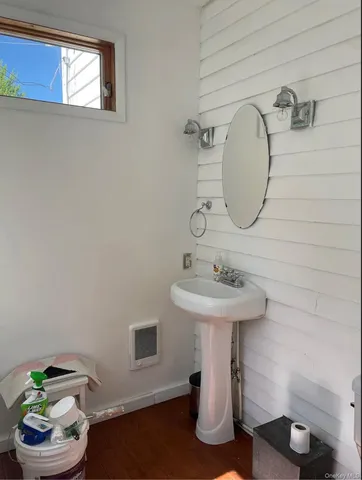 a bathroom with a sink toilet and a mirror
