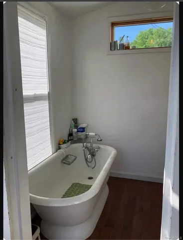 a white bath tub sitting next to a window