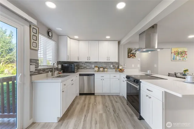 a kitchen with a sink a stove a refrigerator and cabinets