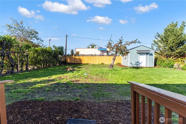 a view of a house with a big yard and potted plants