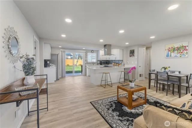 a living room with furniture and kitchen view