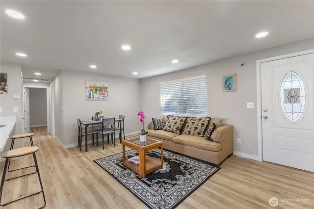 a living room with furniture and a wooden floor