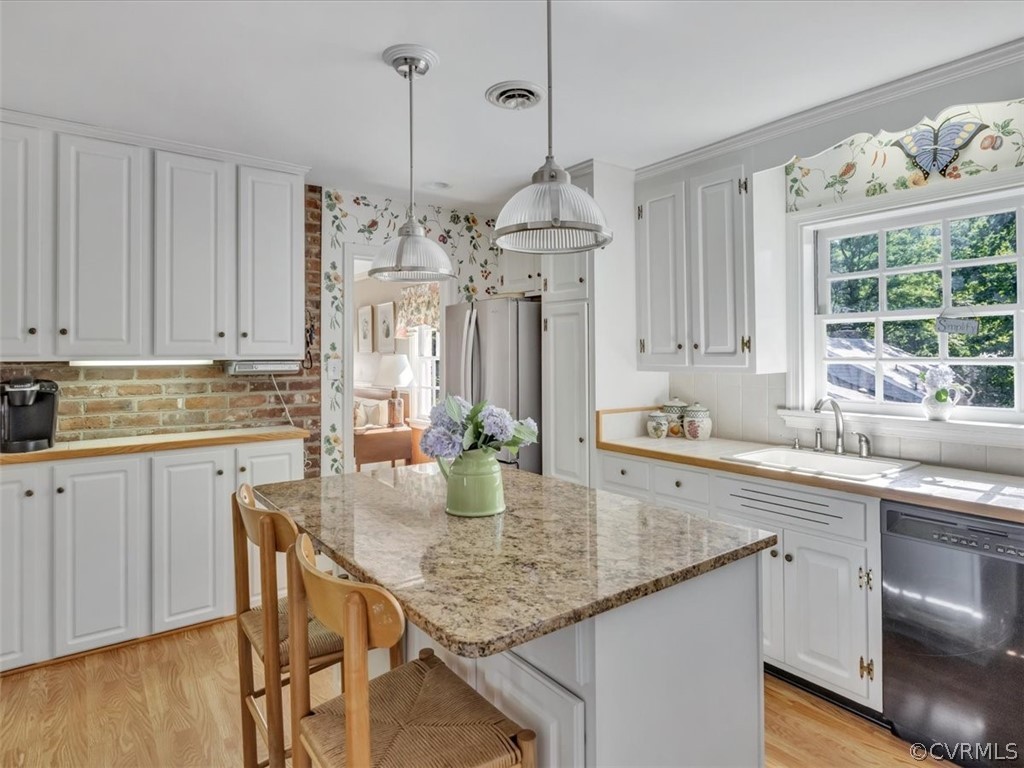 209 Ralston Road Henrico, VA 23229 - Photo 11 of 32 a kitchen with stainless steel appliances granite countertop a sink a stove a dining table and chairs