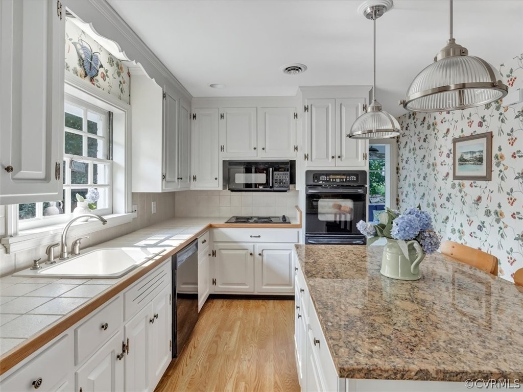 209 Ralston Road Henrico, VA 23229 - Photo 12 of 32 a kitchen with stove cabinets and a wooden floor