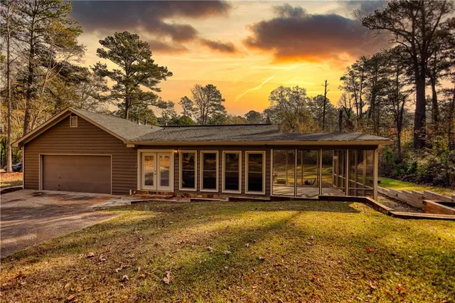 a front view of a house with a yard outdoor seating and garage