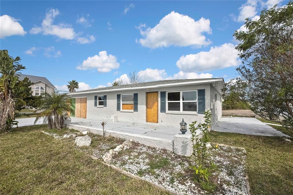 3449 Companero Entra Hernando Beach, FL 34607 - Photo 13 of 31 a front view of a house with garden