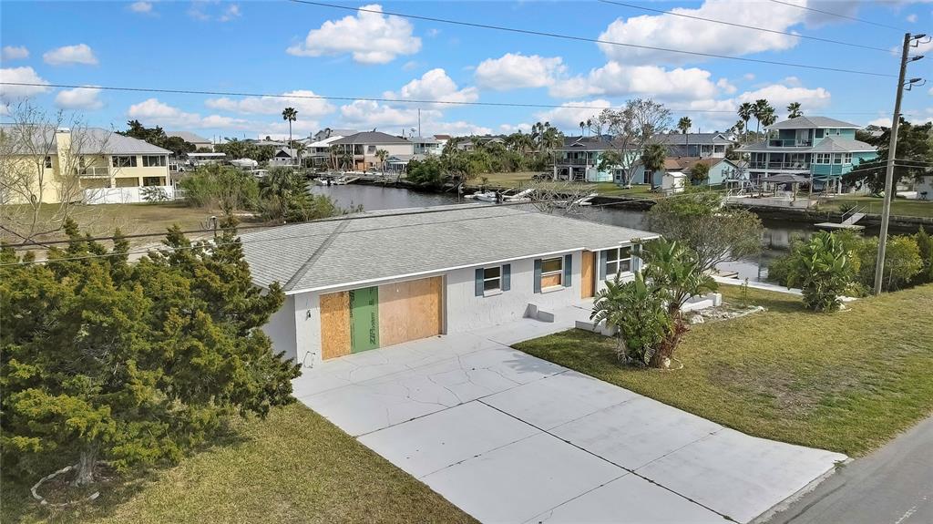 3449 Companero Entra Hernando Beach, FL 34607 - Photo 21 of 31 a front view of a house with a yard