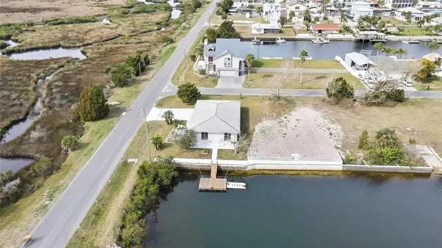 an aerial view of a house with a lake view