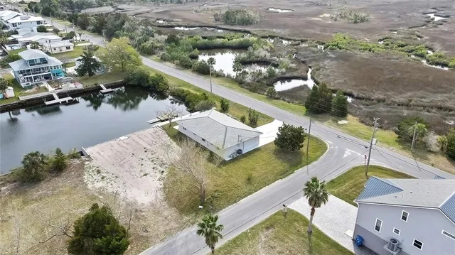 an aerial view of a house with a lake view