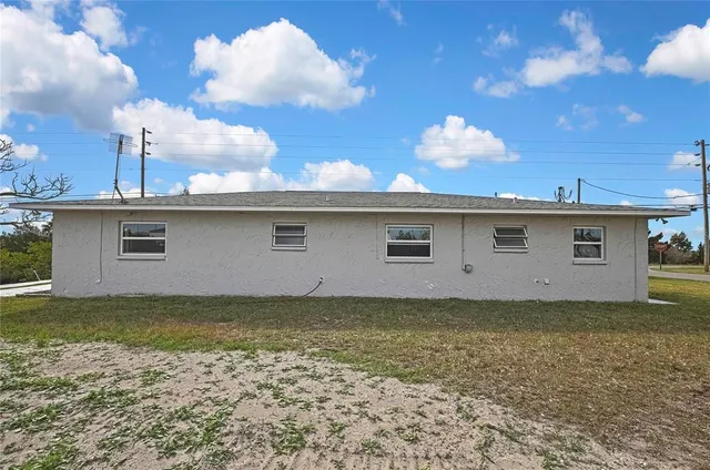 a view of a house with a backyard