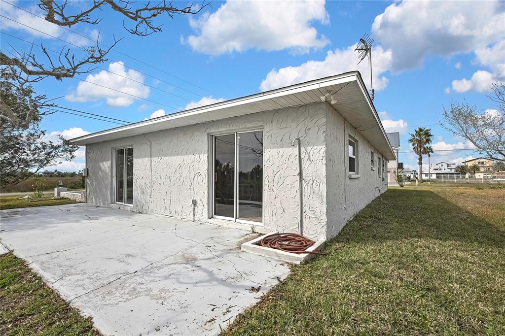 3449 Companero Entra Hernando Beach, FL 34607 - Photo 9 of 31 a view of a house with a yard