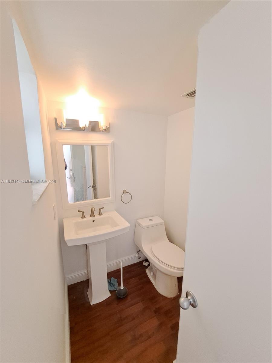 100 Ocean Ln Drive, Unit 403 Key Biscayne, FL 33149 - Photo 13 of 27 a bathroom with a toilet sink and mirror