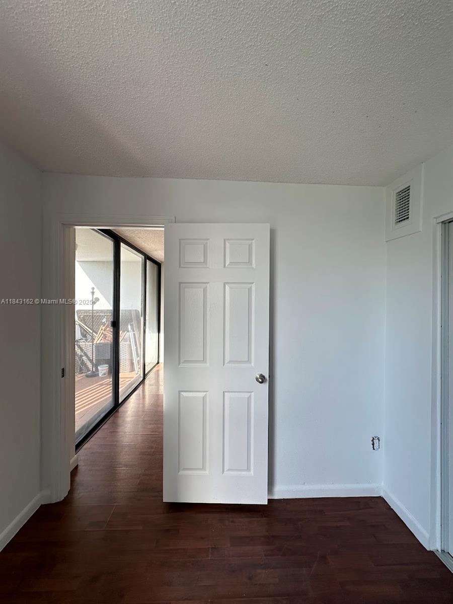 100 Ocean Ln Drive, Unit 403 Key Biscayne, FL 33149 - Photo 18 of 27 a view of an empty room with wooden floor and a window