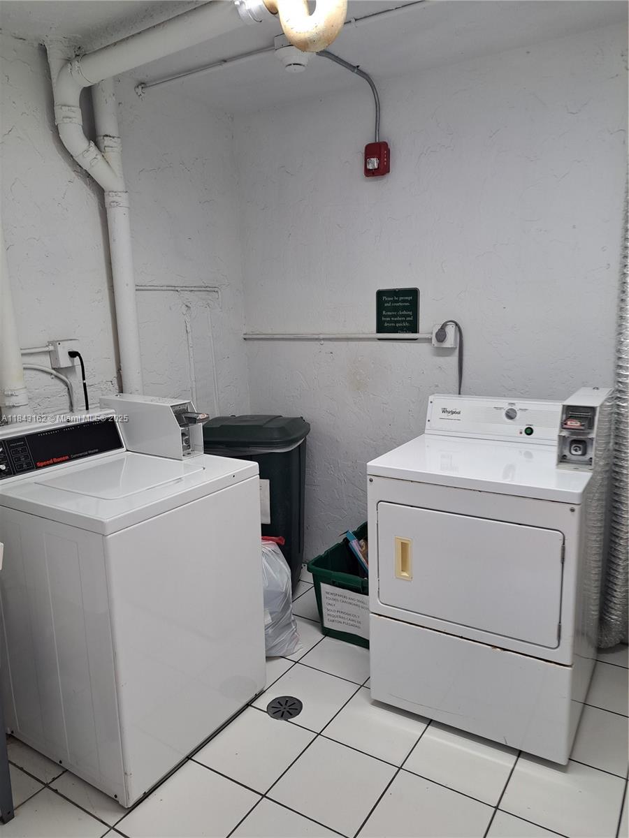 100 Ocean Ln Drive, Unit 403 Key Biscayne, FL 33149 - Photo 25 of 27 a utility room with dryer and washer