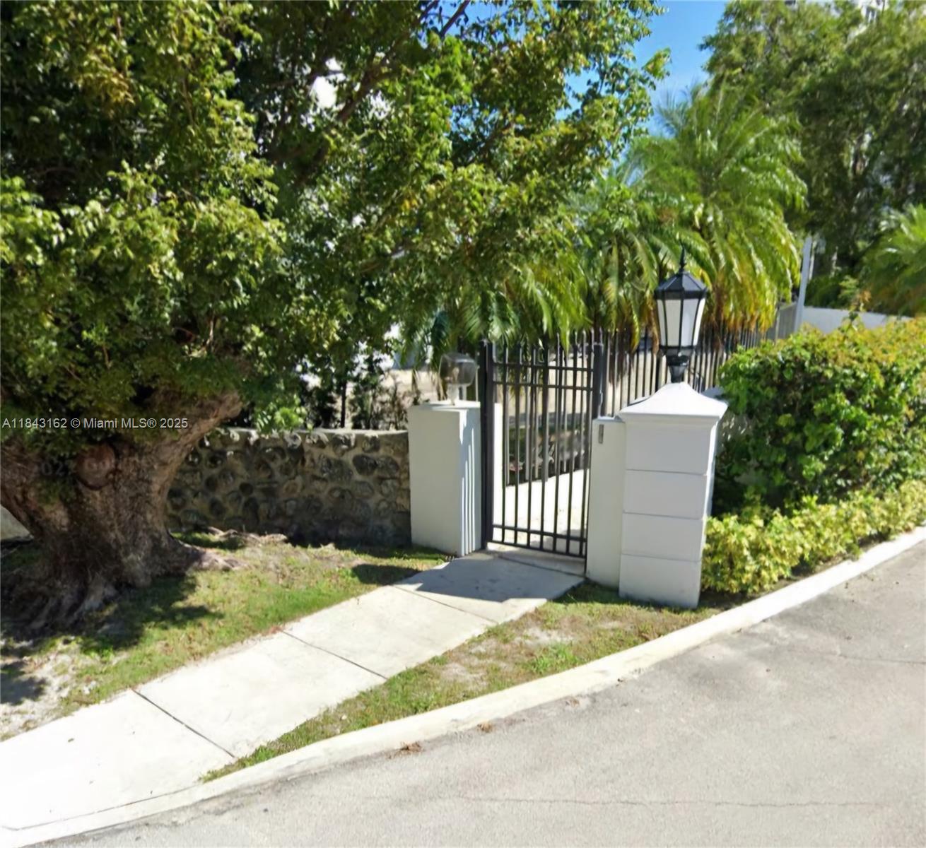 100 Ocean Ln Drive, Unit 403 Key Biscayne, FL 33149 - Photo 6 of 27 a front view of a house with a garden