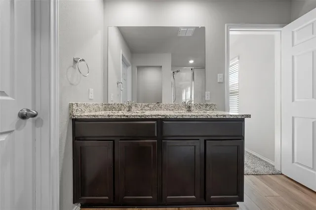 an empty room with windows and ceiling fan