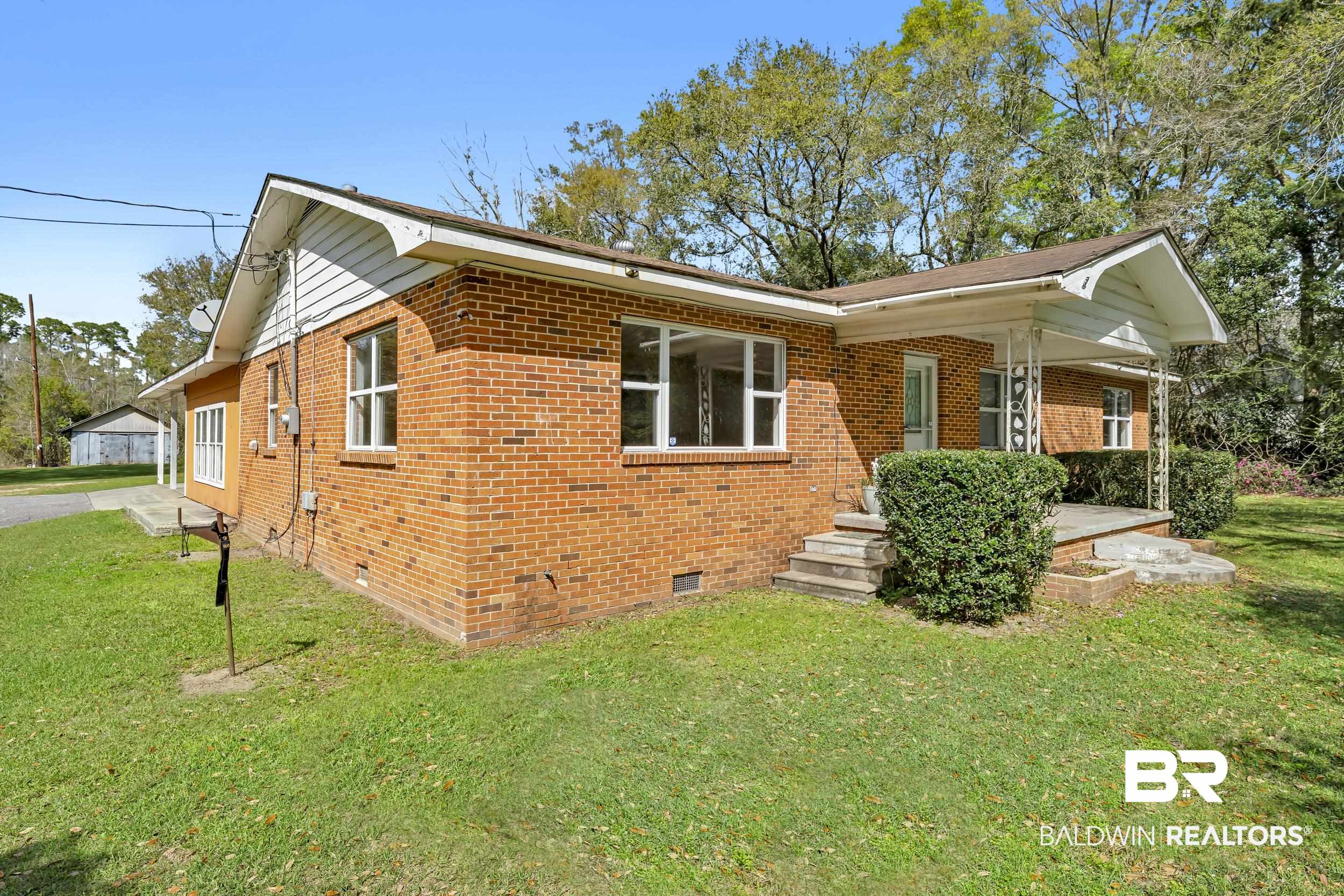 17463 Highway 98 Foley, AL 36535 - Photo 25 of 57 View of front of property with crawl space, brick siding, and a front lawn