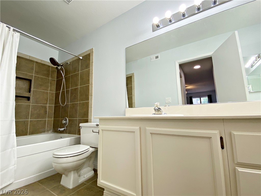 1575 West Warm Springs Road, Unit 1024 Henderson, NV 89014 - Photo 6 of 25 A well-appointed bathroom features a bathtub with a shower, complemented by a broad vanity and mirror.