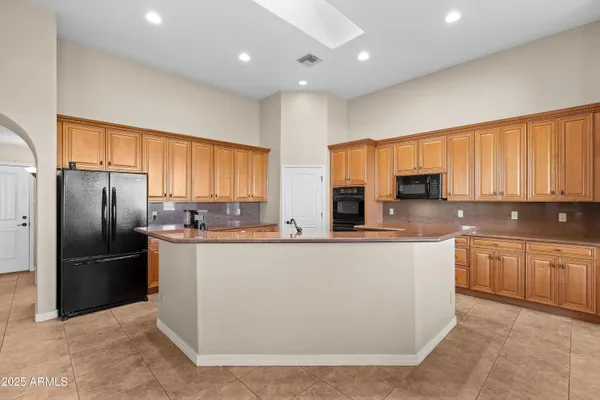 a living room with furniture a chandelier and a window