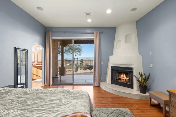 a bedroom with a large bed and a chandelier