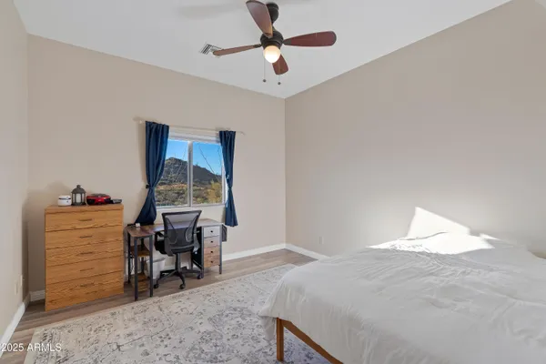 a living room with patio furniture and a floor to ceiling window