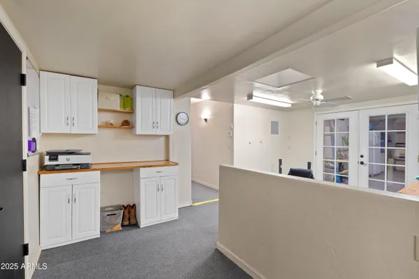 a view of a patio with a table and chairs and potted plants