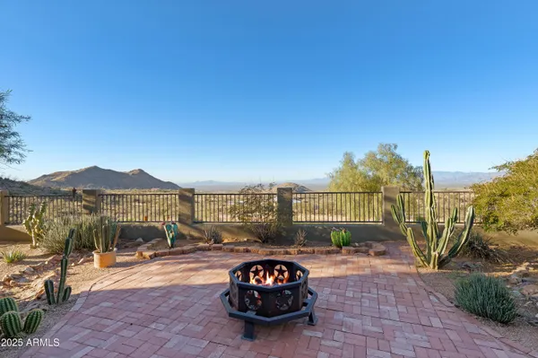 an aerial view of a house with a yard and mountain view