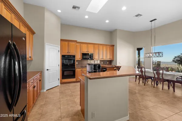 a kitchen that has a sink and a stove top oven