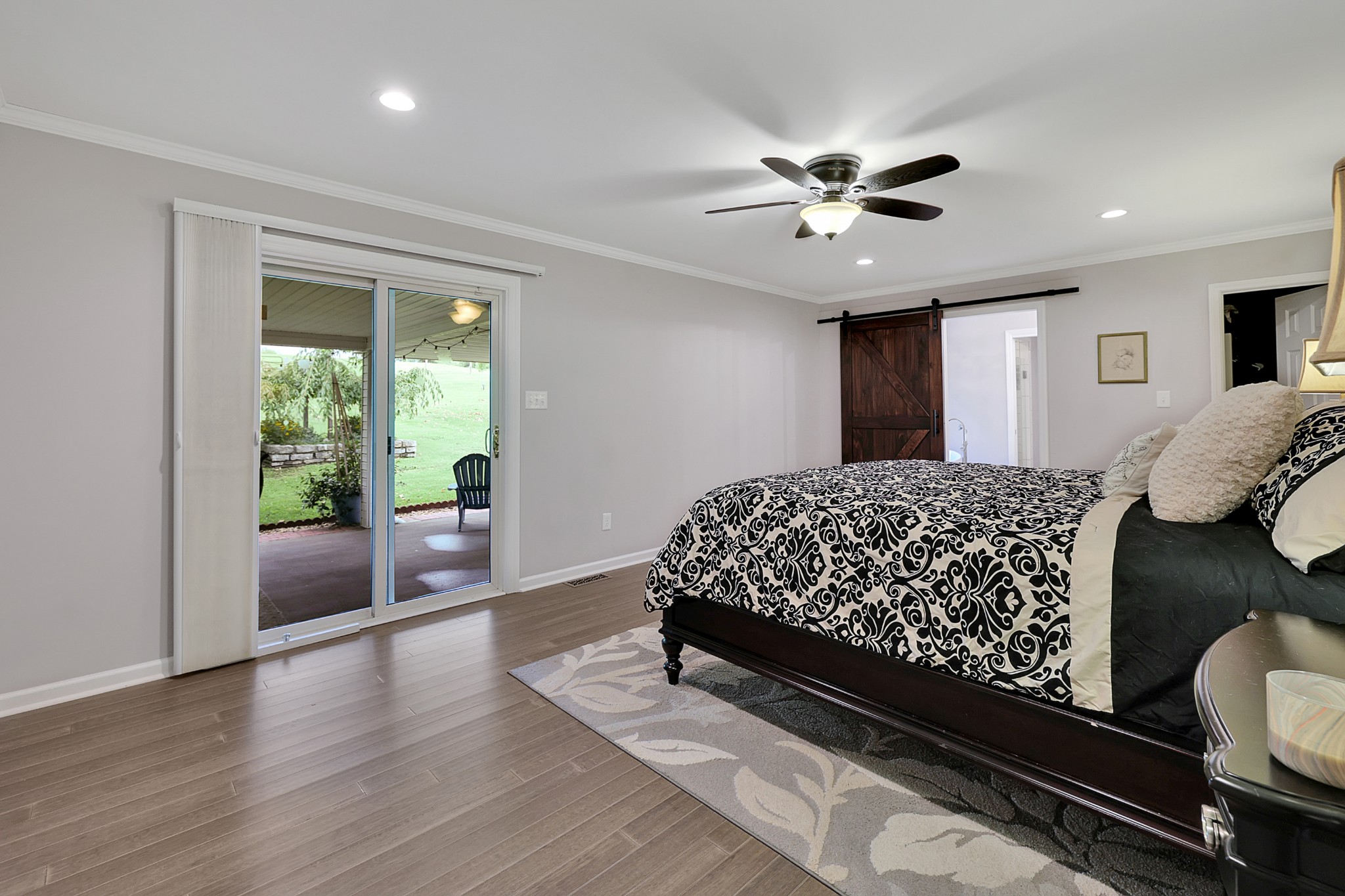1106 Rip Steele Road Columbia, TN 38401 - Photo 20 of 70 a bedroom with a large bed and a chandelier