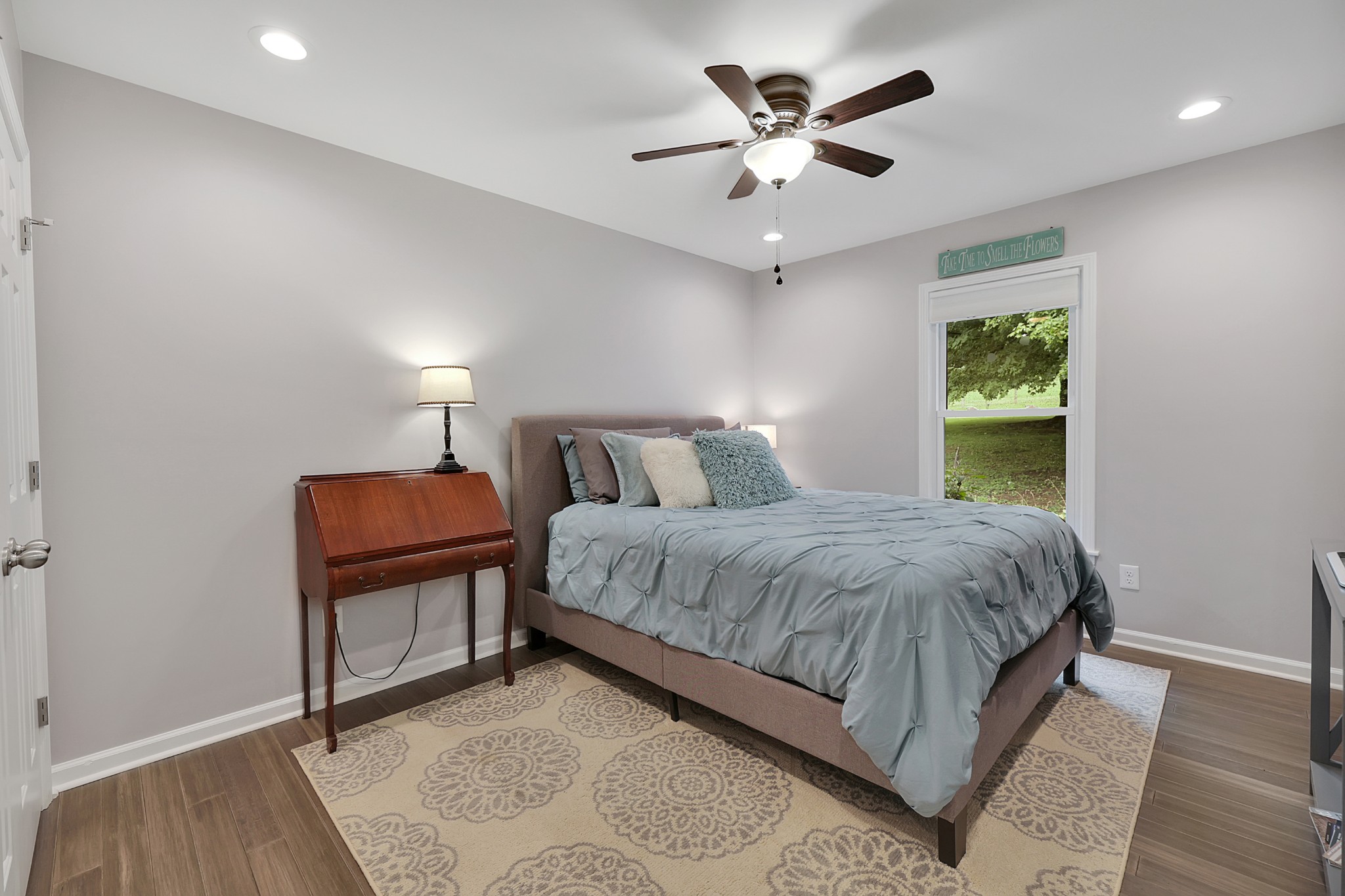1106 Rip Steele Road Columbia, TN 38401 - Photo 26 of 70 a bedroom with a large bed chandelier and a window