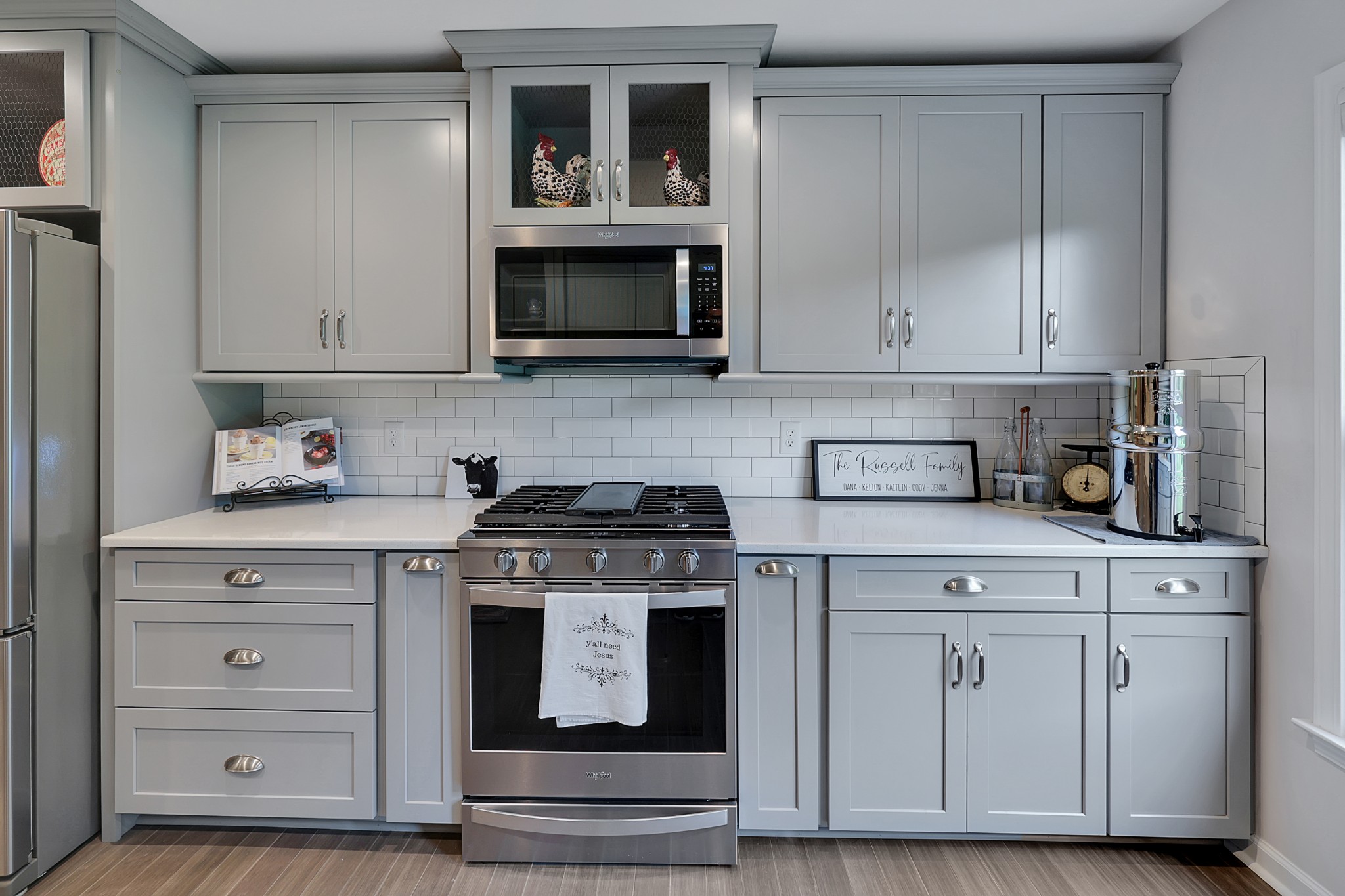 1106 Rip Steele Road Columbia, TN 38401 - Photo 10 of 70 a kitchen with white cabinets and a stove with wooden floor