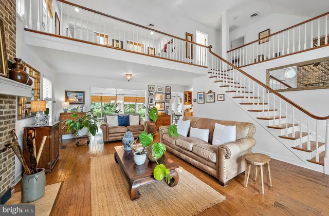 a dining room with furniture and a floor to ceiling window