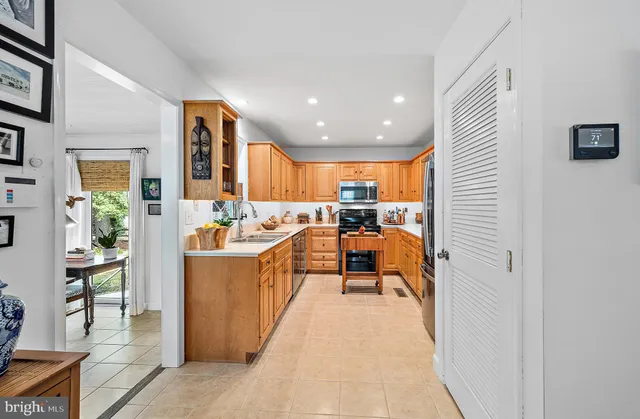 a view of staircase with wooden floor and white walls