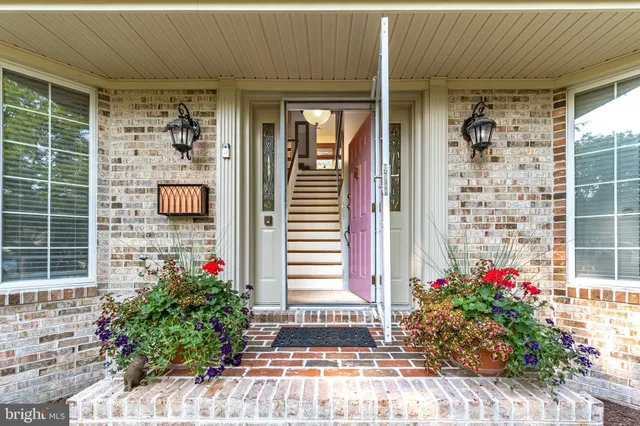 a living room with furniture fireplace and wooden floor