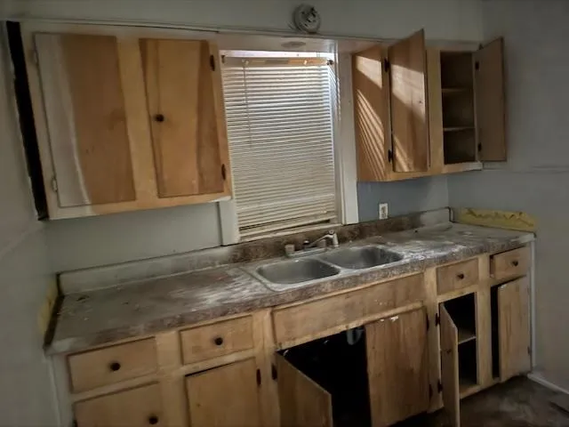 a kitchen with granite countertop a sink and a stove