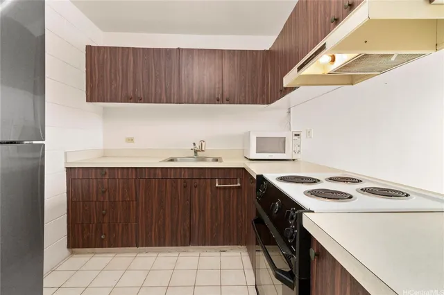 a view of an empty room with wooden floor and doors