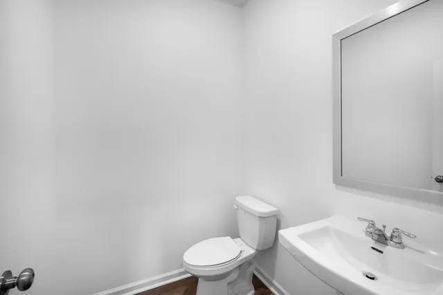 a white toilet sitting next to a white sink